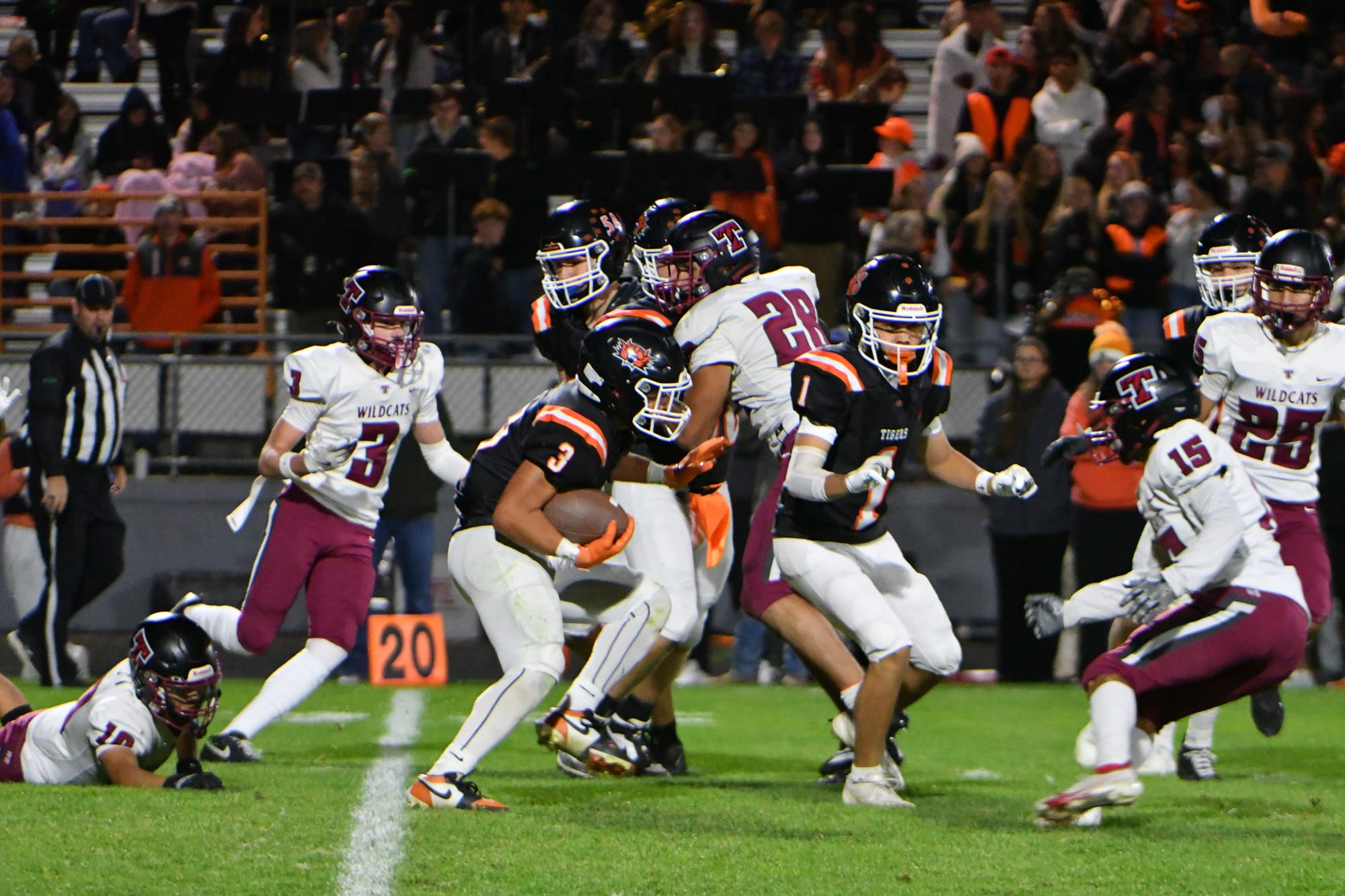 Running back Jacob Reyes (3) picks up first-half yardage following a block from Hunter Mills (1).