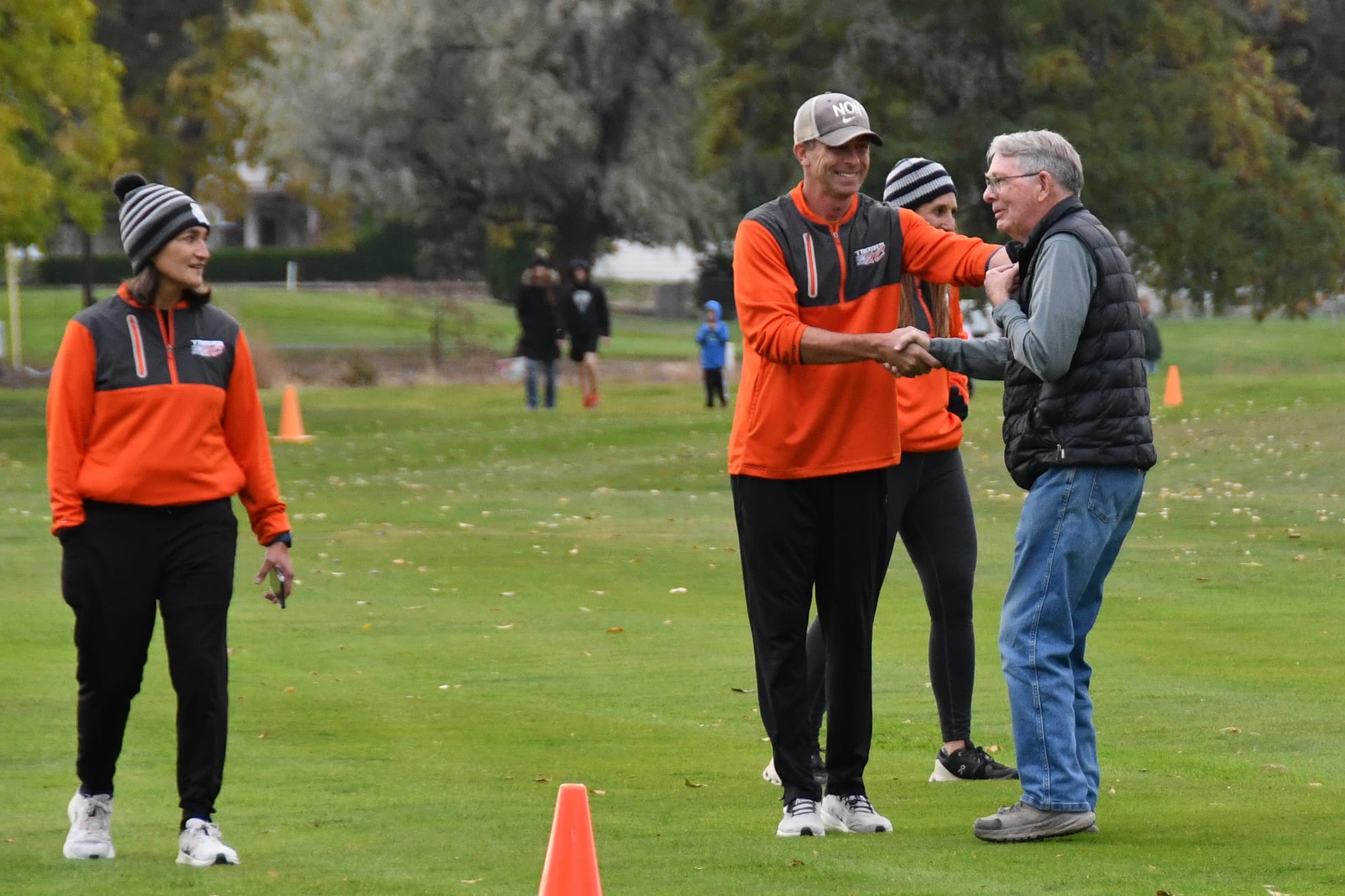 Past meets present as Ephrata head coach Lyndsy Roberts greets his former coach, program legend Don McFarland, at the CWAC league meet in Soap Lake. McFarland launched the Tigers' cross country program in 1971.