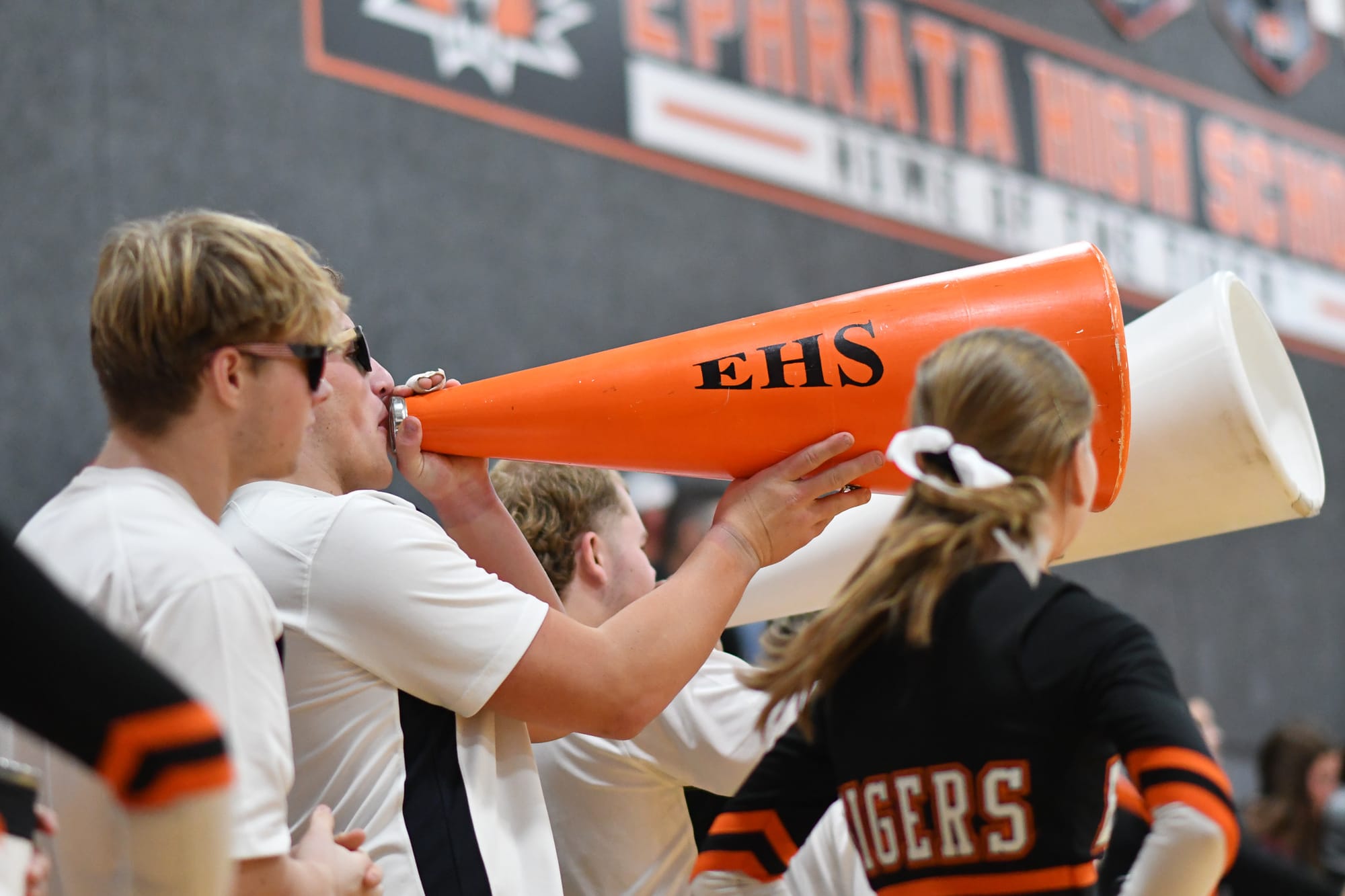 Ephrata stunt team members cheer on the Tigers with megaphones during Saturday's game.