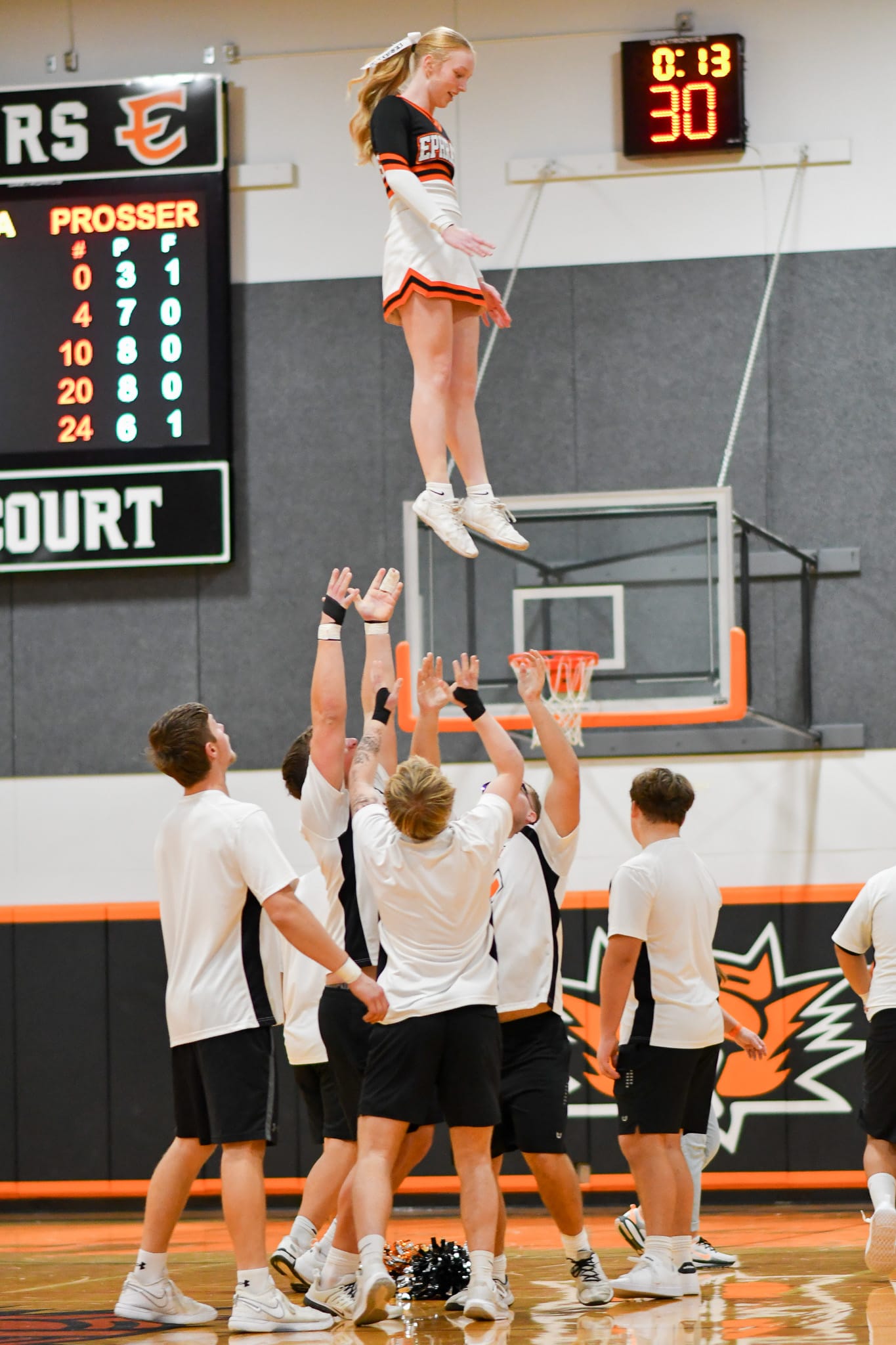 Ephrata stunt team members catch a teammate after a lift during Saturday's game against Prosser.