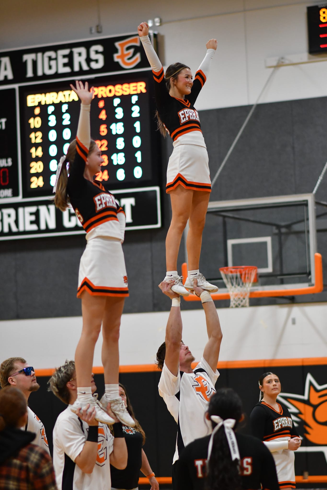Tiger cheer and stunt partners Charles Poirrier and Isabel Deherrera (left), and Cooper Kriete and Jaelyn Brown (right) execute a series of lifts during a break in the action.