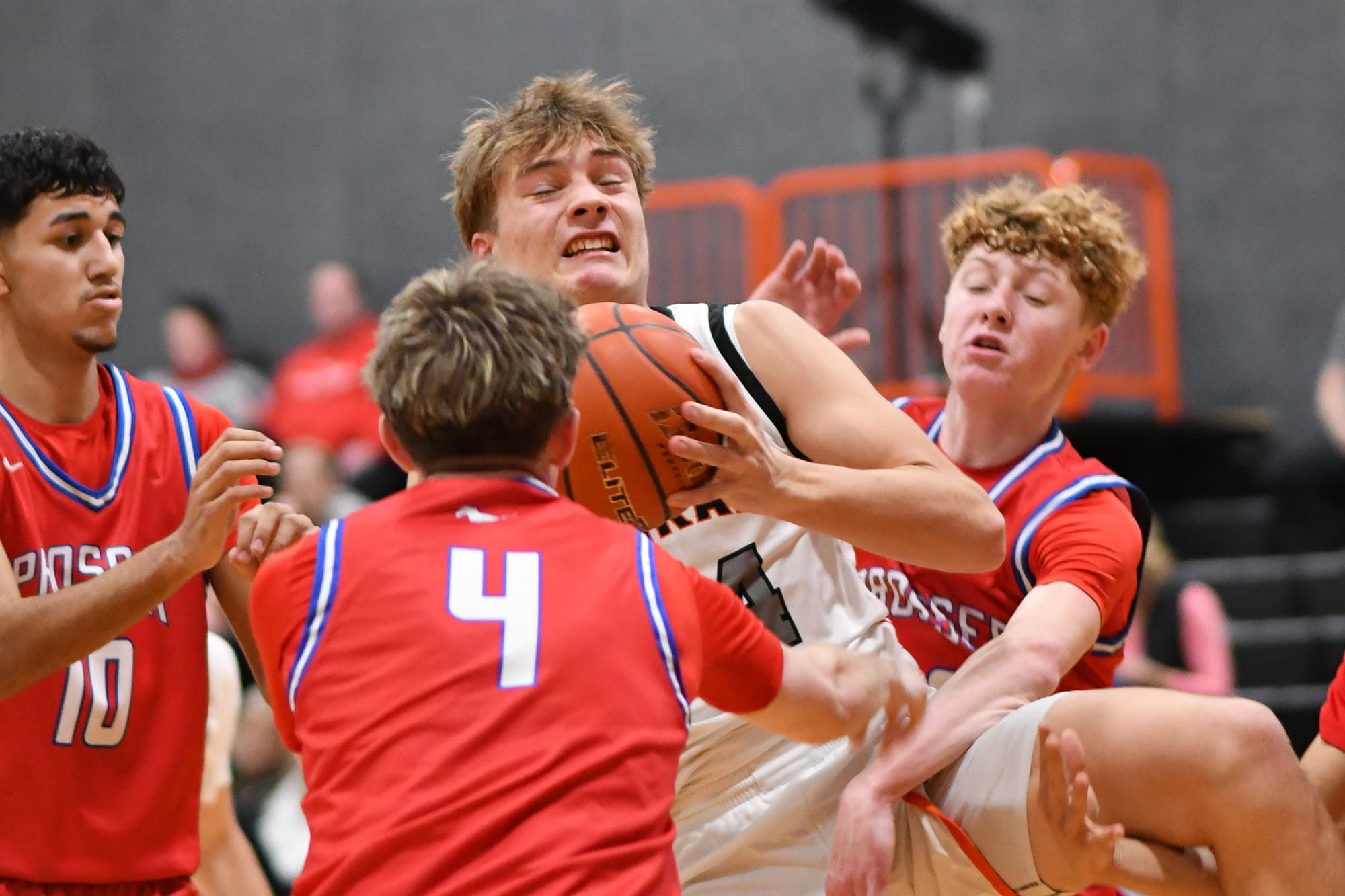 Mitchell Morford (24) is surrounded by Prosser defenders after grabbing a rebound. Morford finished with 11 rebounds in the loss.