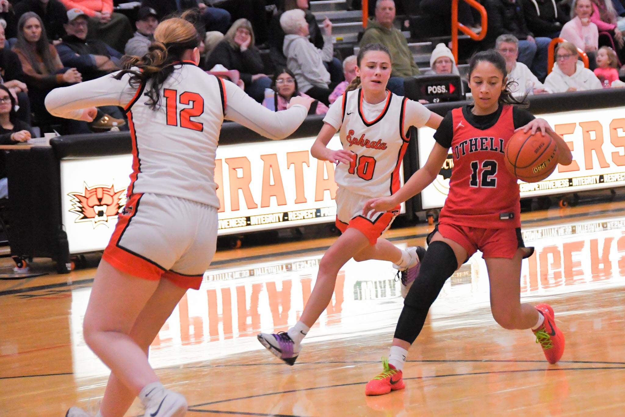 Ephrata's Sophie Molitor (10) and Bailey Falconer (12) cut off a drive by Othello's Abcde Garza (12). Molitor spured the Tiger offense with 17 points across the three-game series.