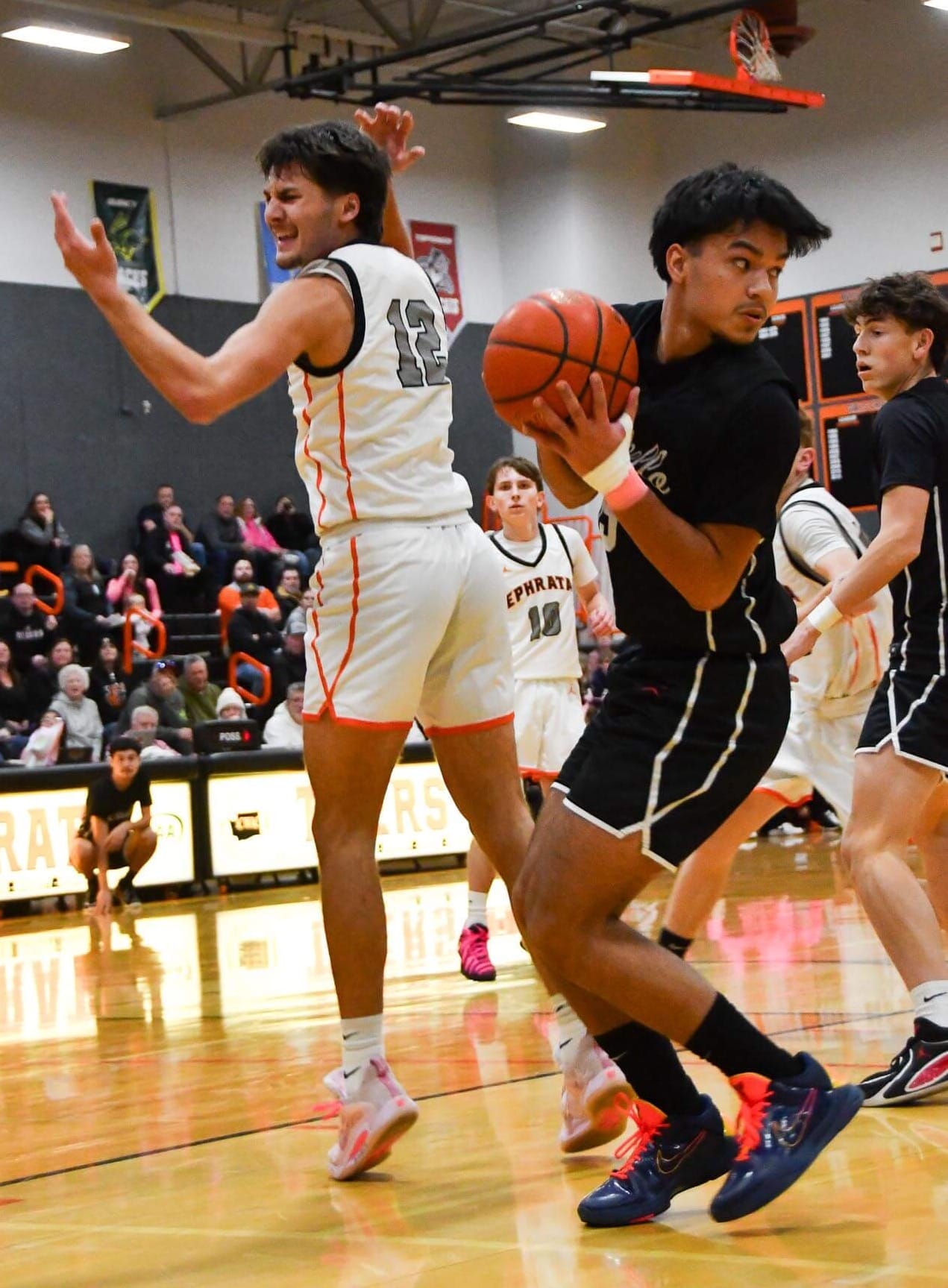 Brady Hendrick wants a whistle after Othello's LJ Nunez forces a turnover Tuesday night. Hendrick finished with 10 points and five assists in the three-point loss.