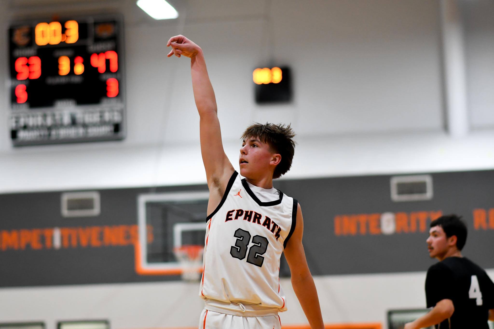 Caiden Weber (32) beats the buzzer with a three-point attempt against Othello. Weber finished with 15 points and two steals in Tuesday's 71-68 loss.