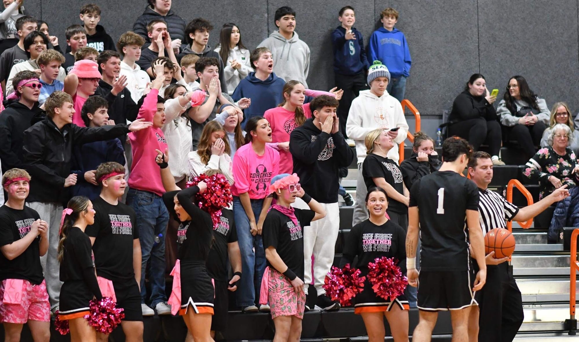 The Ephrata student section, decked out in pink for Coaches vs. Cancer night, reacts to a controversial out-of-bounds call late in the fourth quarter against Othello.