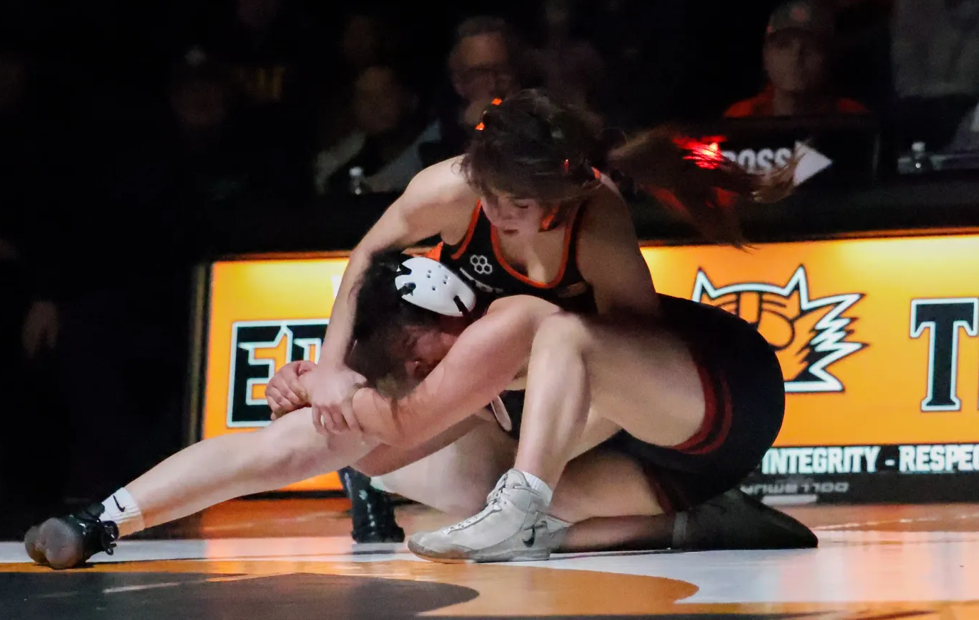 Lady Tiger senior Adylene Sanchez (top) battles to escape Toppenish's Islah Alcala during Thursday's dual. On Senior Night, Sanchez won 7-1 to earn her 100th career win and went 2-2 at the weekend Lady Huskie Invitational.