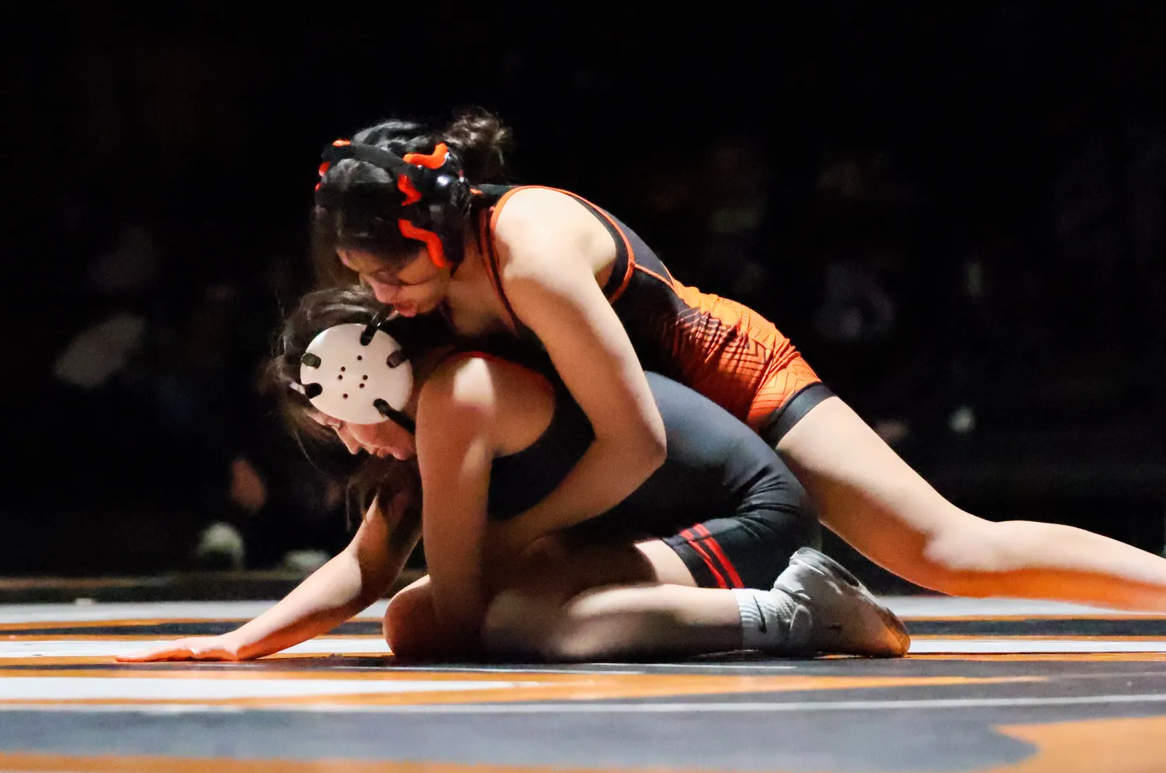 Senior Alexandra Estrada Rangel works from top position against Toppenish's Tayen Grover on Senior Night. Estrada Rangel pinned Grover to reach 100 career wins.