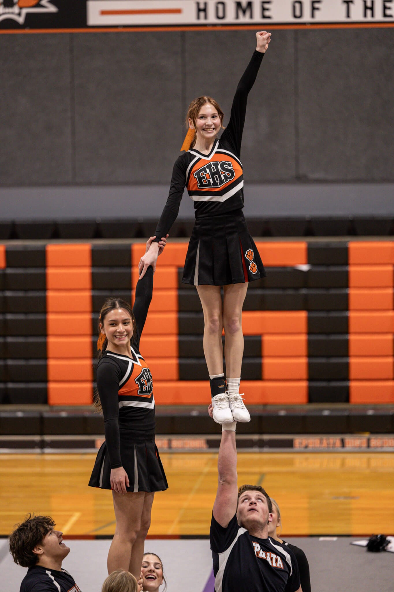 Ephrata's Chastaty Garcia-Zepeda and Isabelle DeHerrera clasp hands while being lifted by their stunt partners.